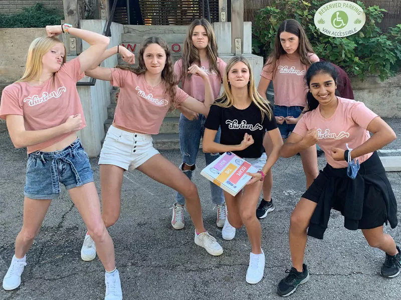 girls in pink t-shirts flexing and posing